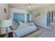 Bright bedroom featuring blue doors, tile floors, neutral decor, and plenty of closet space at 5253 Boardwalk St, Holiday, FL 34690