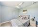 Comfortable bedroom with neutral tones, a ceiling fan, and ample natural light at 5253 Boardwalk St, Holiday, FL 34690