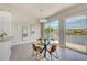 Chic dining area with a modern chandelier and sliding doors to a scenic waterfront balcony at 5253 Boardwalk St, Holiday, FL 34690