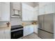 Contemporary kitchen showcasing stainless steel appliances, white cabinets, and ample countertop space at 5253 Boardwalk St, Holiday, FL 34690