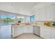 Bright kitchen with white cabinets, granite countertops, stainless steel appliances and water views at 5253 Boardwalk St, Holiday, FL 34690