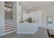 Well-lit kitchen featuring sleek white cabinetry, stainless steel appliances, and a convenient breakfast bar at 5253 Boardwalk St, Holiday, FL 34690