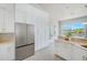 Stylish kitchen featuring white cabinets, stainless steel refrigerator, and scenic water views at 5253 Boardwalk St, Holiday, FL 34690