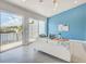 Comfortable living room with sliding glass doors leading to a waterfront balcony and a stylish accent wall at 5253 Boardwalk St, Holiday, FL 34690
