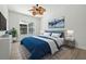 Bright bedroom features a king-size bed, ceiling fan, and two art pieces above the bed at 5390 Greystone Dr, Spring Hill, FL 34609