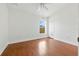 Bright bedroom with hardwood floors, closet, a ceiling fan, and a view of the outside at 5390 Greystone Dr, Spring Hill, FL 34609