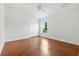 Bright bedroom with hardwood floors, neutral walls, ceiling fan, and closet at 5390 Greystone Dr, Spring Hill, FL 34609