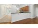 Bright kitchen with wooden cabinets, granite counters, and hardwood floors, next to dining area at 5390 Greystone Dr, Spring Hill, FL 34609