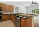 Kitchen with stainless steel dishwasher, granite countertops, and wooden cabinets at 5390 Greystone Dr, Spring Hill, FL 34609
