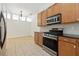 Kitchen with stainless steel range and microwave, and wooden cabinetry at 5390 Greystone Dr, Spring Hill, FL 34609