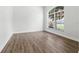 Bright living room boasts a large arched window and pristine wood flooring at 5390 Greystone Dr, Spring Hill, FL 34609