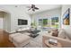 Bright living room features high ceilings, hardwood floors, and sliding glass doors leading to an outdoor patio at 5390 Greystone Dr, Spring Hill, FL 34609
