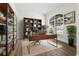 Home office features a large window with natural light, a modern desk, and built-in bookshelves for storage at 5390 Greystone Dr, Spring Hill, FL 34609
