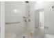 Modern bathroom with a tiled shower, grab bar, and bench seat in a bright and clean setting at 5390 Greystone Dr, Spring Hill, FL 34609