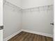 Spacious walk-in closet with wood-style flooring and metal shelving to organize clothes and accessories at 5390 Greystone Dr, Spring Hill, FL 34609