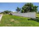Backyard of a single-story home with a white fence and lush lawn, providing privacy and space at 5401 7Th N Ave, St Petersburg, FL 33710