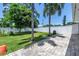 Large backyard featuring a brick patio, mature trees, and a privacy fence at 5401 7Th N Ave, St Petersburg, FL 33710