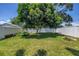 Lush backyard featuring a mature tree and a white privacy fence at 5401 7Th N Ave, St Petersburg, FL 33710
