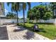 Spacious backyard featuring lush green grass, mature trees, and a patio area at 5401 7Th N Ave, St Petersburg, FL 33710