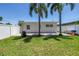 Backyard featuring lush green grass, mature trees, and a brick patio area at 5401 7Th N Ave, St Petersburg, FL 33710