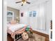 Bright bedroom with hardwood floors, ceiling fan, and cozy decor at 5401 7Th N Ave, St Petersburg, FL 33710