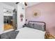 Bright bedroom with pink accent wall looking into the kitchen and dining area at 5401 7Th N Ave, St Petersburg, FL 33710