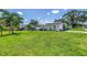 Well-maintained single-story home with a lush green lawn and mature landscaping under a bright, sunny sky at 5401 7Th N Ave, St Petersburg, FL 33710