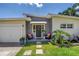 Charming front entrance with a well-maintained lawn, seating, and potted plants enhancing curb appeal at 5401 7Th N Ave, St Petersburg, FL 33710