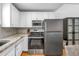 Bright kitchen with white cabinets and stainless-steel appliances at 5401 7Th N Ave, St Petersburg, FL 33710