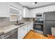 Charming kitchen featuring white cabinets, stainless steel appliances, and stone countertops at 5401 7Th N Ave, St Petersburg, FL 33710