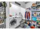 Functional laundry room with modern washer and dryer, shelving, and ample storage space at 5401 7Th N Ave, St Petersburg, FL 33710