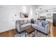 Comfortable living room with modern décor and hardwood floors flows into the dining area at 5401 7Th N Ave, St Petersburg, FL 33710
