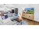 Cozy living room featuring an entertainment center and seamless flow into the kitchen at 5401 7Th N Ave, St Petersburg, FL 33710