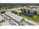 An aerial view displays the condo complex with its pond, pool, and surrounding area at 6000 20Th N St # 123, St Petersburg, FL 33714