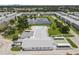 An aerial view showcases the building, the pond, and the pool area in this lovely community at 6000 20Th N St # 123, St Petersburg, FL 33714