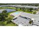 Aerial view shows the building, pond, and pool area with lounge seating at 6000 20Th N St # 123, St Petersburg, FL 33714