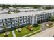 Low-angle view of a condo building with a well-manicured lawn and mature landscaping at 6000 20Th N St # 123, St Petersburg, FL 33714