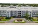 An inviting condominium building with well-maintained landscaping and a circular driveway at 6000 20Th N St # 123, St Petersburg, FL 33714