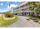 Exterior of condo featuring manicured landscaping and circle driveway at 6000 20Th N St # 123, St Petersburg, FL 33714