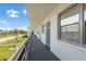 Exterior hallway featuring unit doors, and access to manicured landscaping with palm trees at 6000 20Th N St # 123, St Petersburg, FL 33714