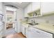 This functional kitchen offers white cabinets, light countertops, and easy access to the laundry room at 6000 20Th N St # 123, St Petersburg, FL 33714