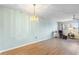 A spacious living room with wood-look floors and a decorative chandelier at 6000 20Th N St # 123, St Petersburg, FL 33714