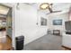 Cozy living room features neutral tones, ceiling fan, and view into the kitchen at 6000 20Th N St # 123, St Petersburg, FL 33714