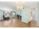 This living room features a ceiling fan, chandelier, and lots of natural light at 6000 20Th N St # 123, St Petersburg, FL 33714