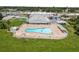 Enjoy this large community pool, surrounded by lounge chairs, umbrellas, and a white fence at 6000 20Th N St # 123, St Petersburg, FL 33714
