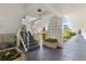 Stairwell featuring gray stairs, brick planters, and access to landscaping with palm trees at 6000 20Th N St # 123, St Petersburg, FL 33714