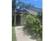 Charming entryway with lush greenery and a decorative arch at 6262 142 N Ave # 1001, Clearwater, FL 33760