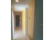 Long hallway with neutral walls, tile flooring, and recessed lighting at 6262 142 N Ave # 1001, Clearwater, FL 33760