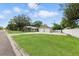 Spacious home with a large front yard, detached two-car garage, and mature trees offers curb appeal and space at 6301 Hobson Ne St, St Petersburg, FL 33702