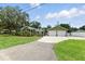 Charming exterior view of home with a screened porch and a detached two-car garage at 6301 Hobson Ne St, St Petersburg, FL 33702